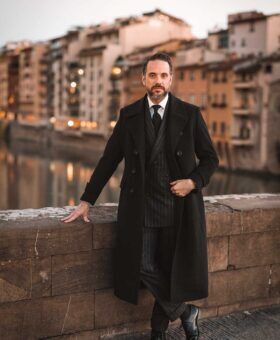 brian sacawa at pitti uomo 103 wearing a charcoal greatcoat near the ponte vecchio