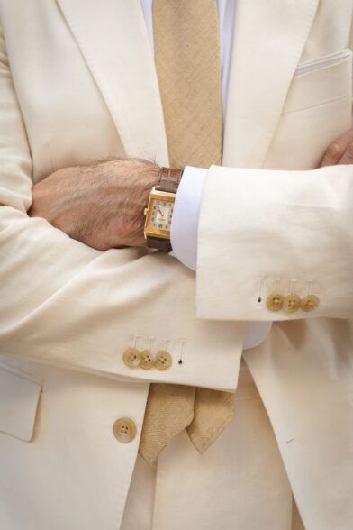A Jaeger-LeCoultre Reverso in gold paired with a cream linen suit