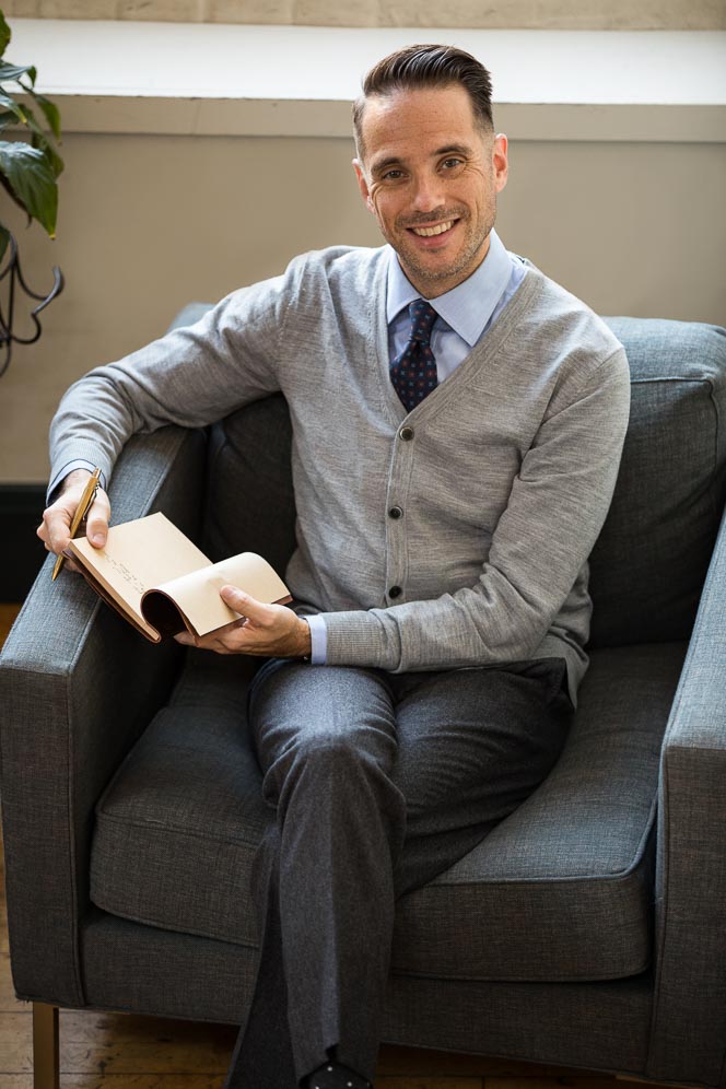 cardigan dress shirt tie A basic scene. Male model + cardigan, tie, tie clip, portfolio in arms.  Hair gelled up