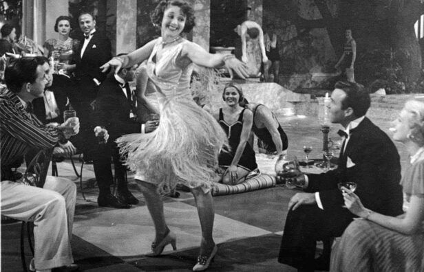 A flapper from the Roaring 20s dancing in a cocktail dress