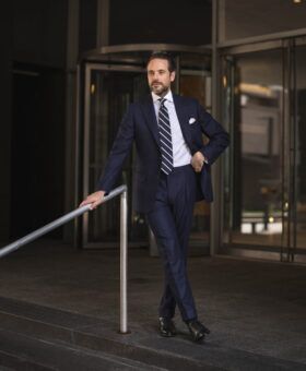 Made-to-measure navy blue flannel suit styled for fall and winter versatility.