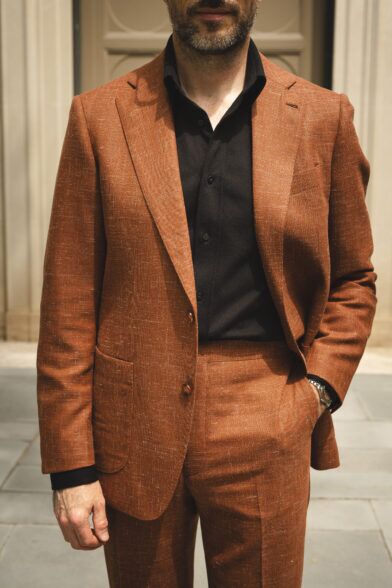 terracotta suit in hopsack styled with a black shirt