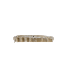 Cream horn dressing comb with fine and wide teeth and a small monogram, flat lay