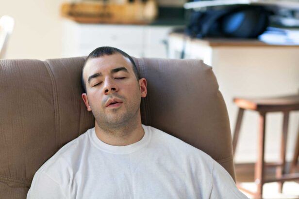 A lazy man sits in an easy chair