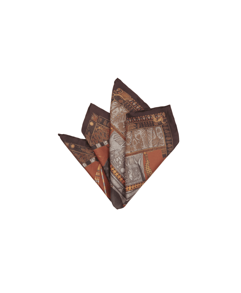Rust and dark brown silk pocket square with Egyptian-motif print, shown folded in a multi-point fold