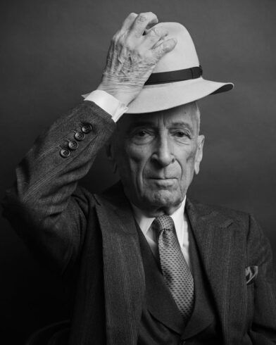 Light felt fedora with a dark grosgrain band, worn with a pinstripe three-piece suit, black and white