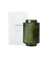 Fir and cedarwood soy candle in ribbed green glass jar with lid, shown with its white gift box
