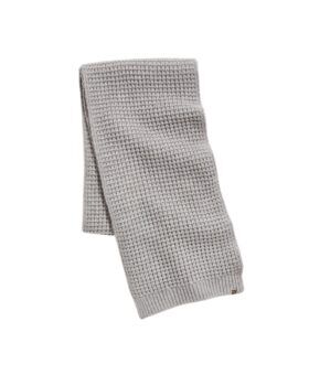 Light grey waffle-knit wool scarf with ribbed edges, folded flat lay