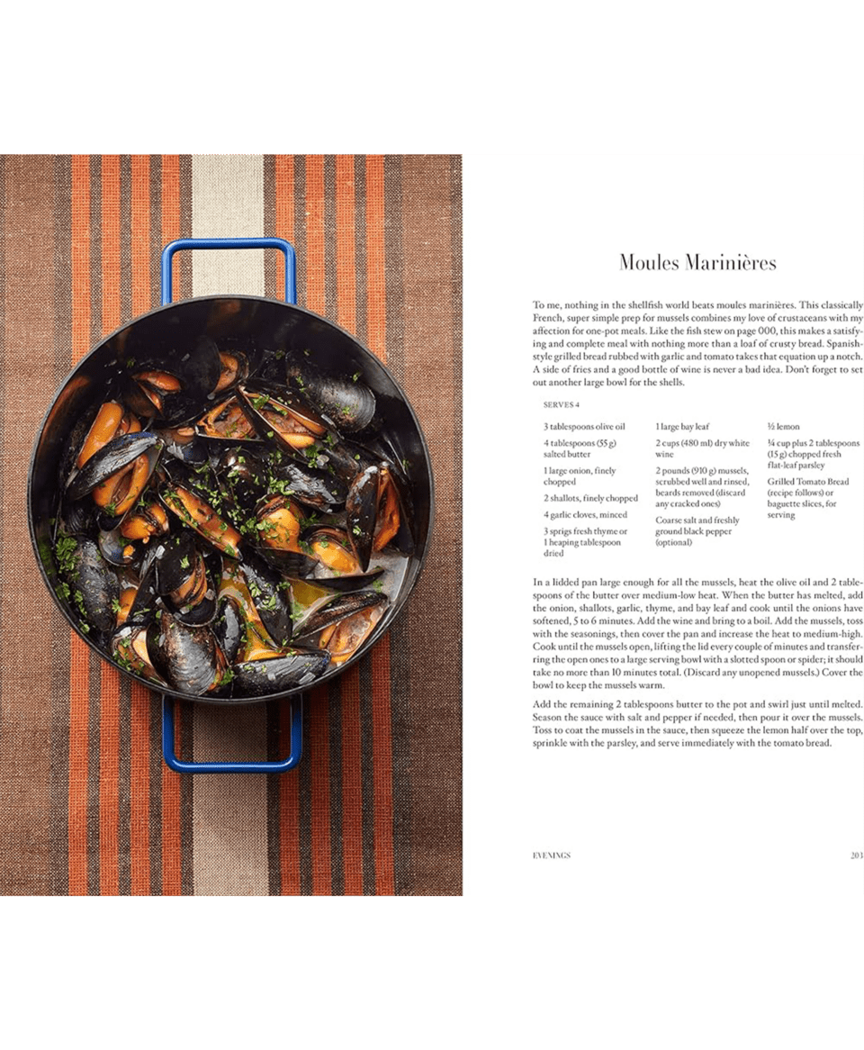 Cookbook spread showing a Moules Mariniu00e8res recipe beside a blue-handled pan of mussels on a striped cloth