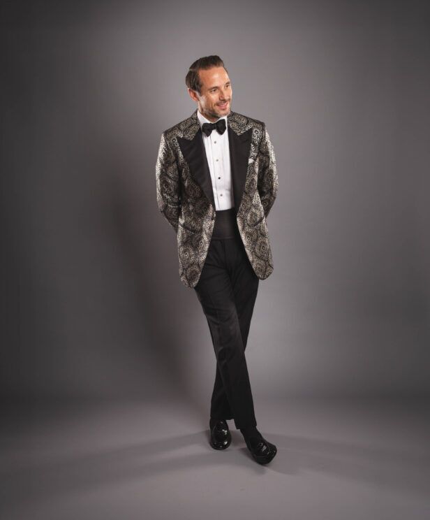 Black and gold paisley brocade dinner jacket with black peak lapels, pique shirt and cummerbund