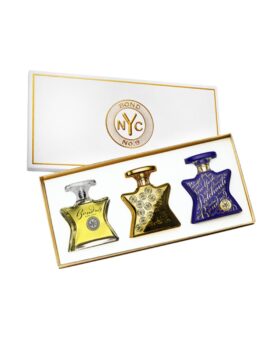 Fragrance gift set of three star-shaped bottles in gold, amber and blue, in an open white and gold box