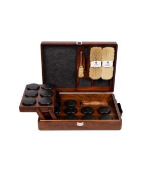 Walnut shoe shine briefcase open to show polish tins, horsehair brushes and applicators