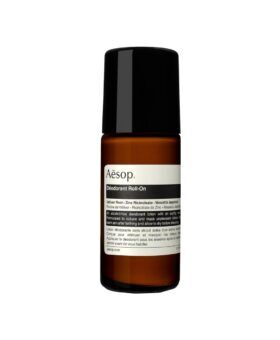 Amber glass roll-on deodorant bottle with a black cap and printed label