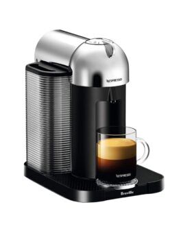 Chrome and black Nespresso Vertuo coffee machine with a filled glass mug, on a white background