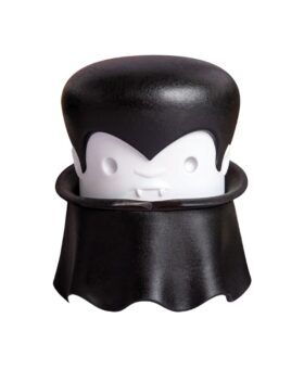 Black and white vampire-shaped garlic crusher with a caped base, front view