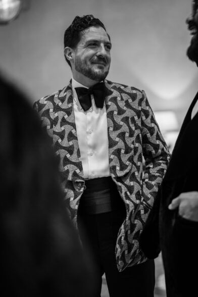 Black and white patterned dinner jacket with bow tie and cummerbund, worn by a guest