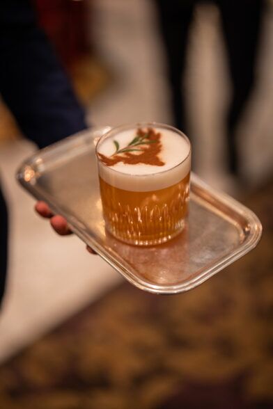Whisky cocktail with a stag dusted in the foam, served on a silver tray