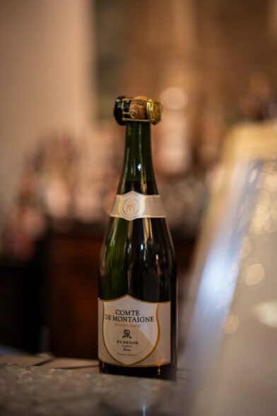Comte de Montaigne champagne bottle with a St Regis Florence label, on a bar