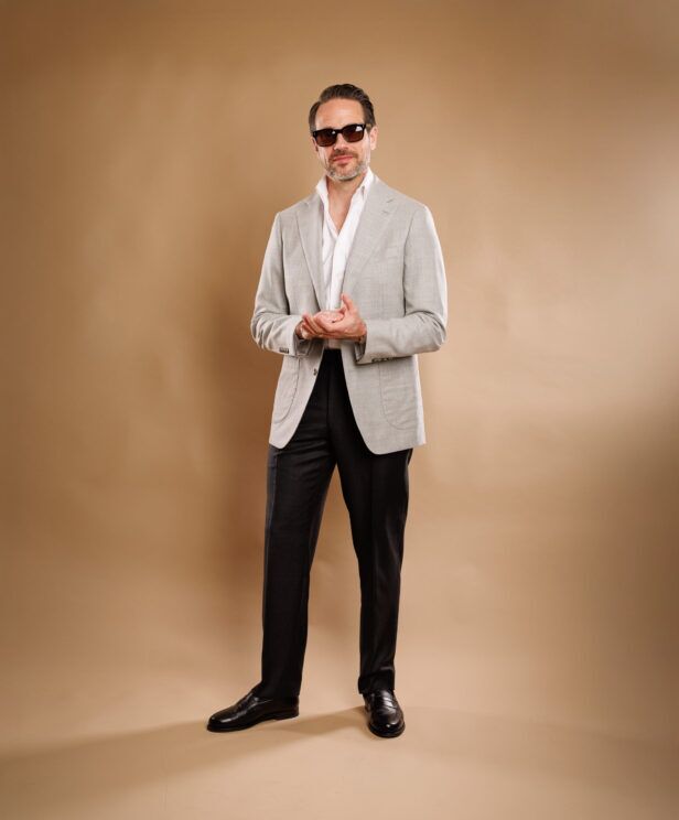 Light grey hopsack sport coat with charcoal trousers and black loafers, full length