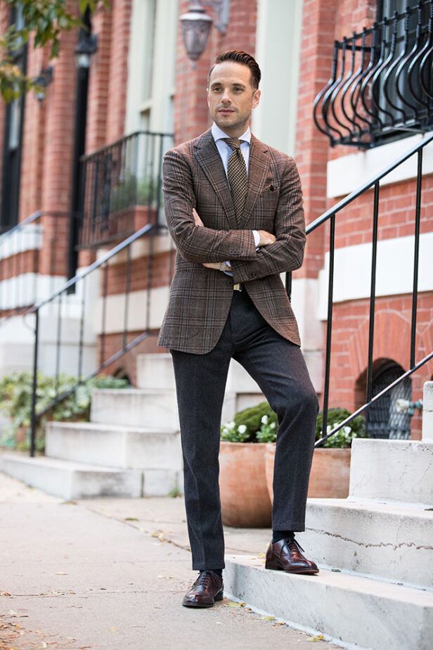 Brown plaid wool sport coat with blue shirt, charcoal flannel trousers and burgundy oxfords, worn by a model