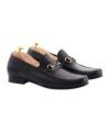Black leather horsebit loafers with silver bit hardware and cedar shoe trees, angled product view