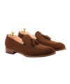 Brown suede tassel loafers with leather soles and cedar shoe trees, product shot