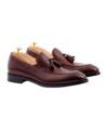 Bordeaux leather tassel loafers with leather soles and cedar shoe trees, angled product view