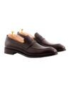 Dark brown full grain leather penny loafers with leather soles and cedar shoe trees, angled product view