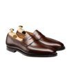 Dark brown polished leather penny loafers with leather soles and shoe trees, product view