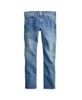 Medium blue washed denim five-pocket slim jeans with faded whiskering, flat lay