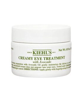 Creamy eye treatment with avocado in a white jar with green lettering, product packaging shot