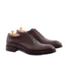 Dark brown leather cap toe oxford shoes with leather soles and cedar shoe trees, product shot
