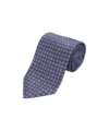 Slate blue silk necktie with small tan and white medallions, rolled flat lay