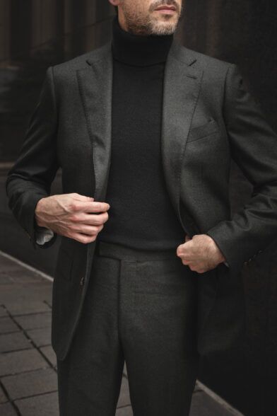 Forest green flannel suit with black turtleneck sweater, worn by a model on a city street