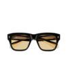 Black square acetate sunglasses with amber tinted lenses and gold temple accents, front flat lay
