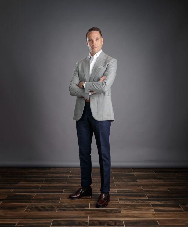 Light grey flannel sport coat with patch pockets, white shirt and navy trousers, worn by a model