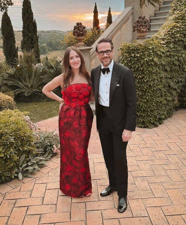 Black tuxedo with peak lapels, pique bib shirt, black bow tie and patent loafers, worn in a sunset garden