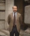 Brown glen plaid flannel sport coat with blue shirt, brown grenadine tie and grey trousers, worn by a model