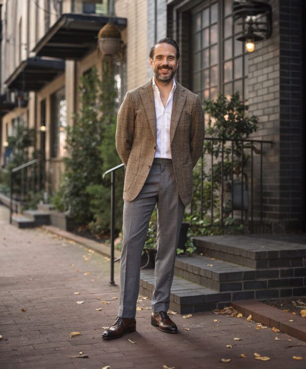 Brown glen plaid wool sport coat with white shirt and grey flannel trousers, on a city sidewalk