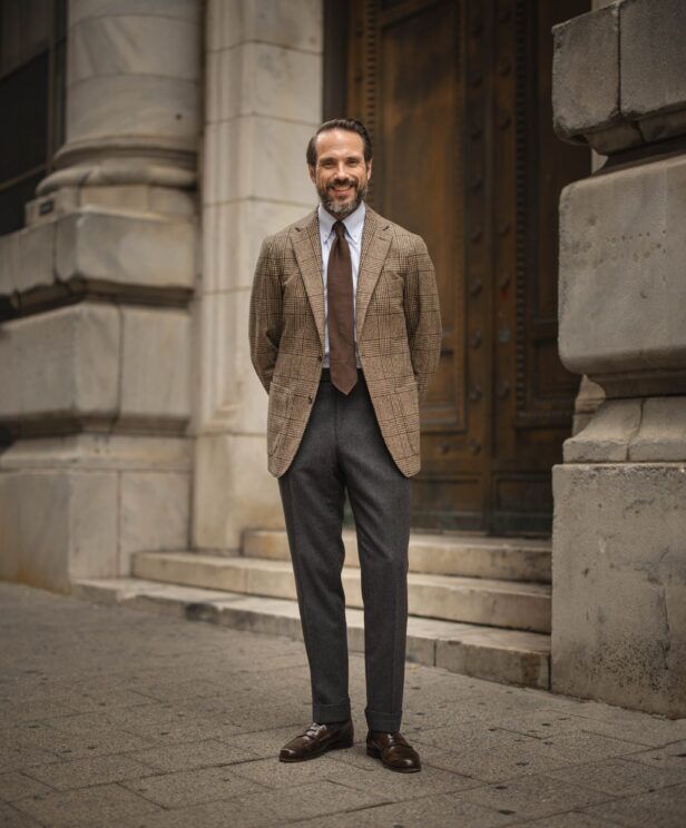 Brown glen plaid wool sport coat with blue shirt, brown grenadine tie and charcoal flannel trousers, worn by a model