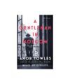 Book cover for "A Gentleman in Moscow" by Amor Towles, black-and-white photo of a suited man at a window