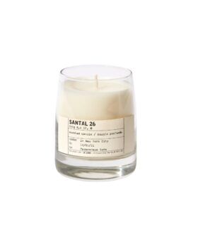 Santal 26 scented candle in clear glass vessel with cream wax and typewriter-style label, product shot