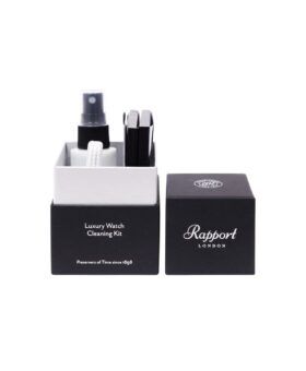 Watch cleaning kit with spray bottle, cloth and brushes in an open black gift box, packaging shot