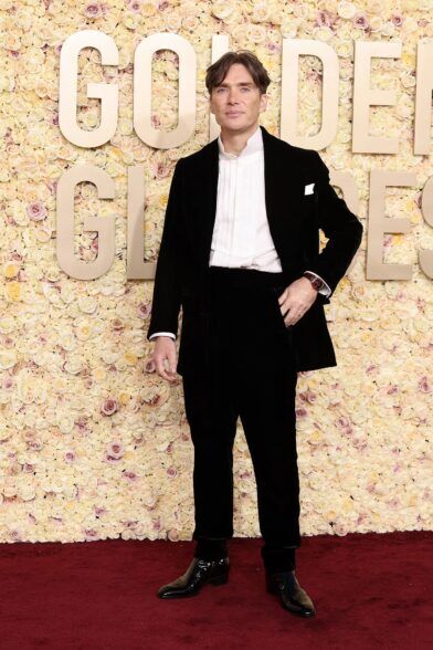 Black velvet dinner suit with white pleated band-collar shirt and patent shoes, worn on a red carpet