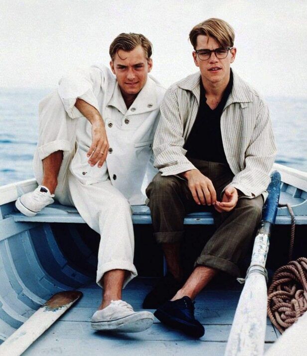 Cream linen jacket and trousers alongside a striped shirt jacket with olive trousers, worn by two men in a boat