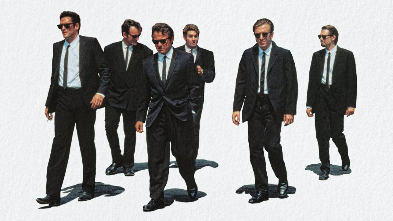 Black suits with white shirts, black neckties and sunglasses, worn by six men walking in a film still