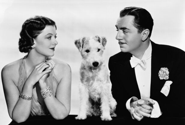 Black tailcoat with white bow tie, wing collar shirt and carnation boutonniere, worn in a vintage black-and-white film still