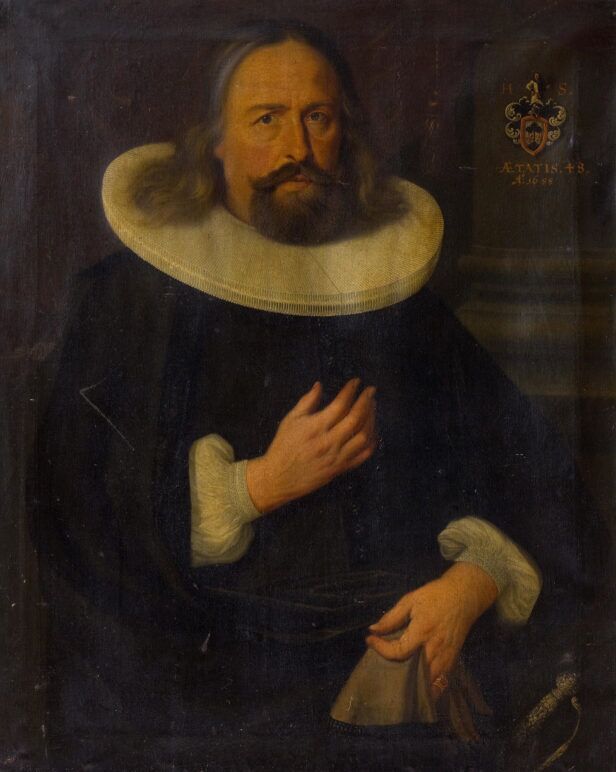 Black doublet with white pleated ruff collar and linen cuffs, worn by a bearded man in a 17th century painted portrait