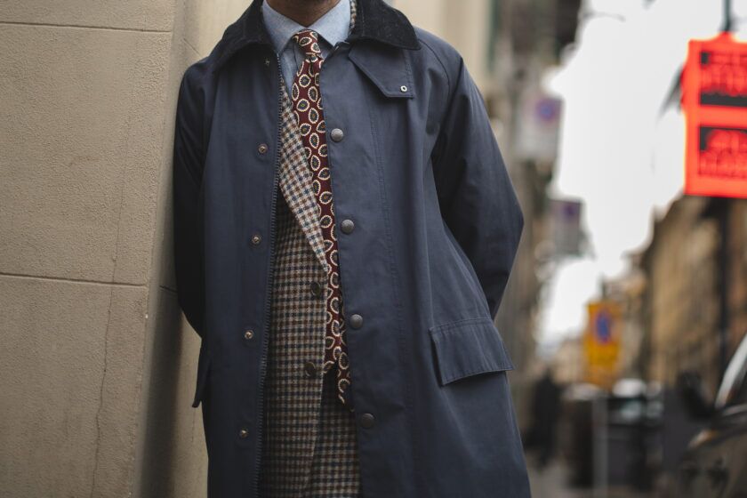 Navy cotton walking coat with corduroy collar over a checked tweed jacket and burgundy tie