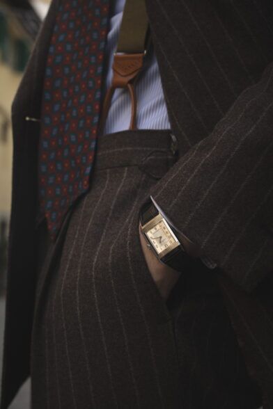 Brown chalkstripe flannel suit with rust medallion silk tie, striped shirt and tan braces, a styled close-up detail